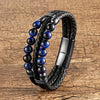 Double wrap black leather bracelet with blue stone beads on wood background
