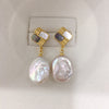 Pair of baroque pearl drop earrings with gold-tone top and silver posts