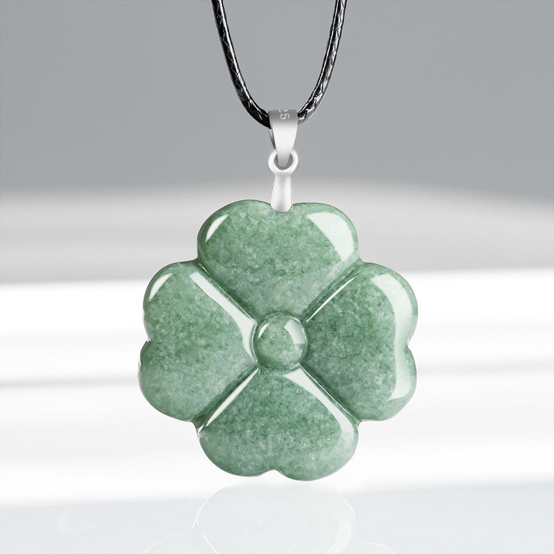 Green jade four leaf clover pendant on a black cord
