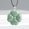Green jade four leaf clover pendant on a black cord