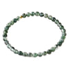 Close up of a green moss agate beaded bracelet on a white background