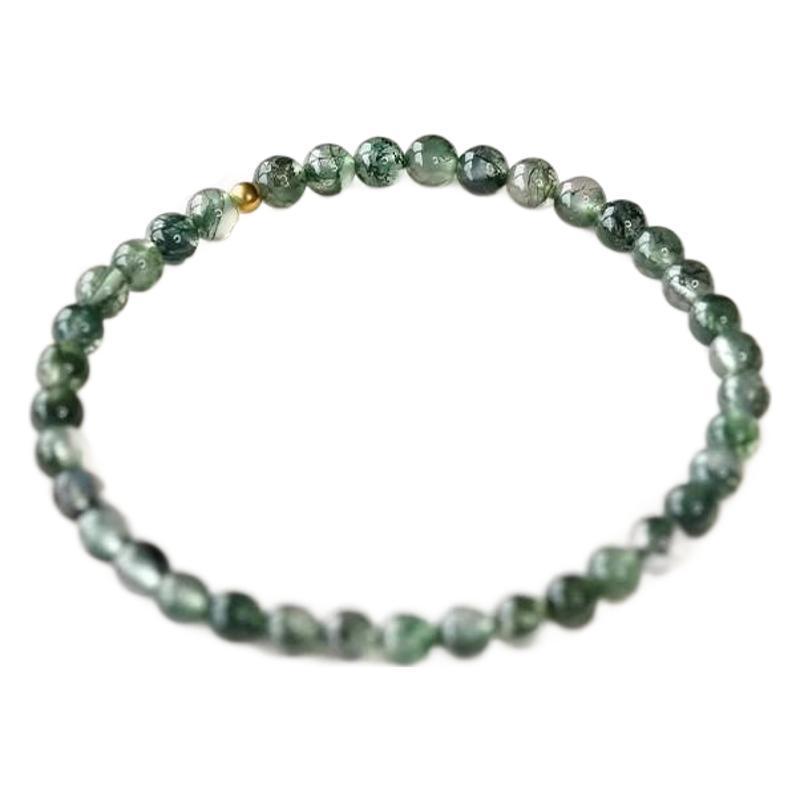 Close up of a green moss agate beaded bracelet on a white background