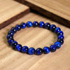 Blue Tiger Eye beaded bracelet on a wooden surface