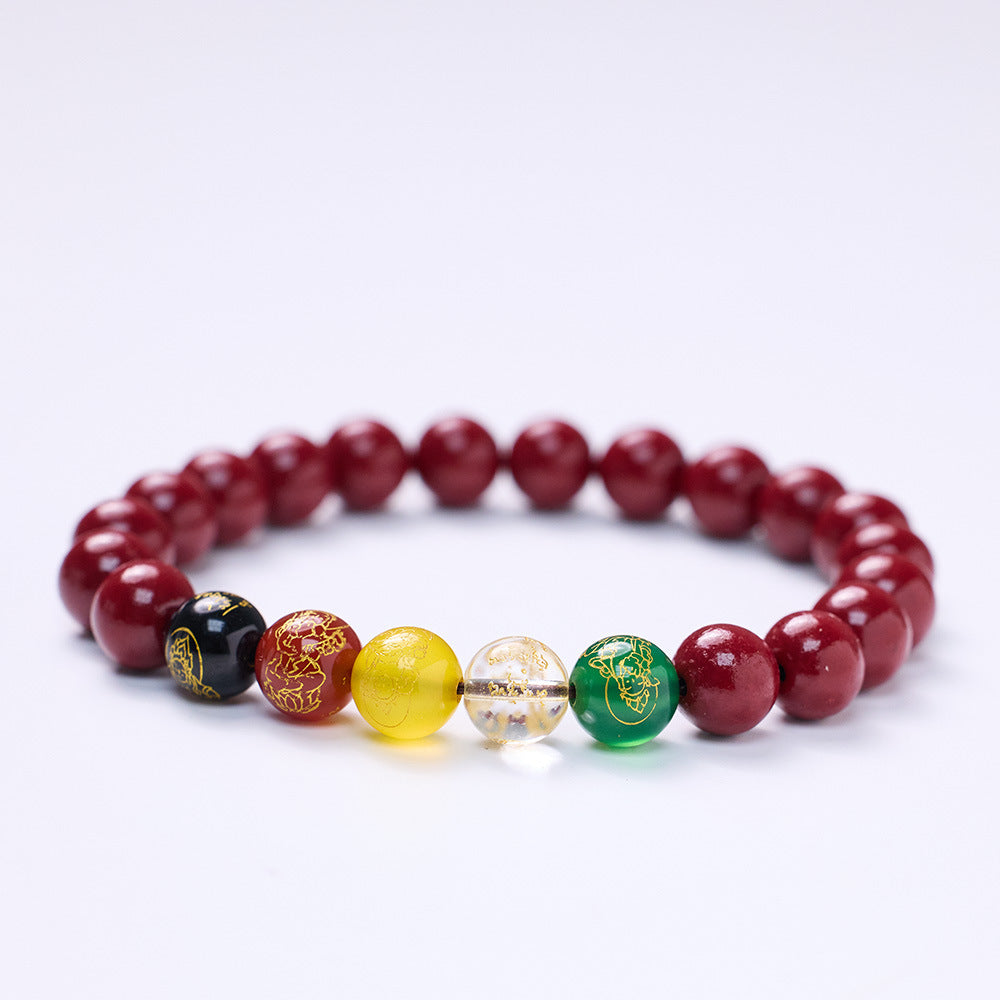 Red cinnabar beaded bracelet with five colored wealth god charms on a wrist