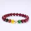 Red cinnabar beaded bracelet with five colored wealth god charms on a wrist