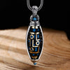 Close up of a silver plated rotatable pendant with blue Dzi patterns
