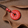 Red cinnabar peace buckle pendant with a carved return pattern on a black cord
