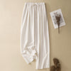 Flat lay of white wide-leg cotton linen pants with a drawstring waist