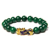 Green agate bead bracelet with gold-tone Pixiu charm on white background