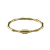 Gold-tone brass bangle bracelet shaped like bamboo segments with a lotus detail