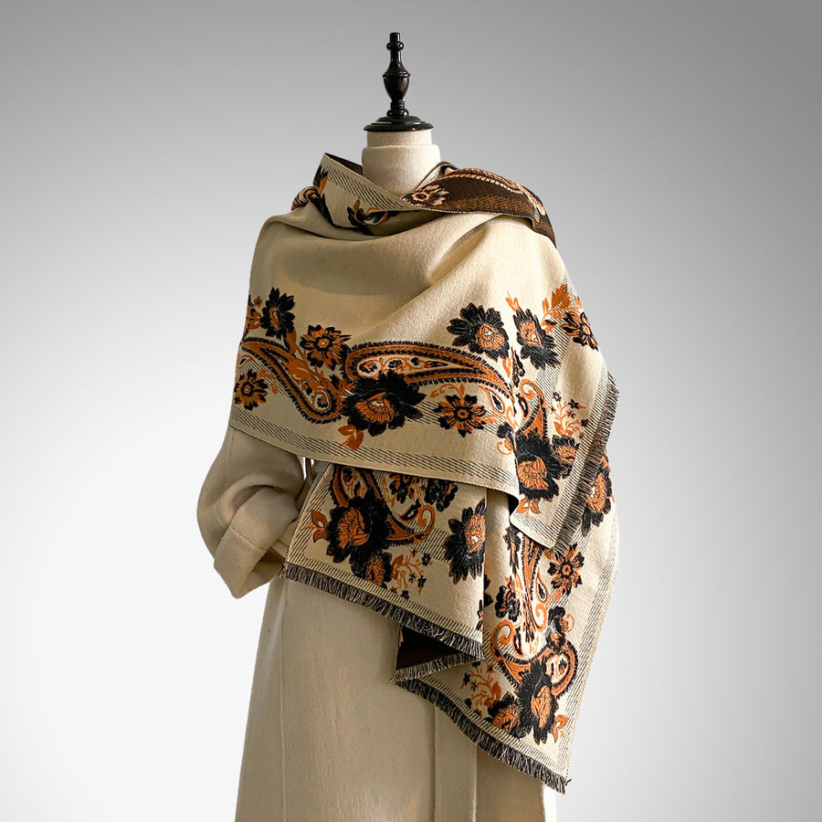 Beige scarf with brown and orange floral patterns draped on a mannequin