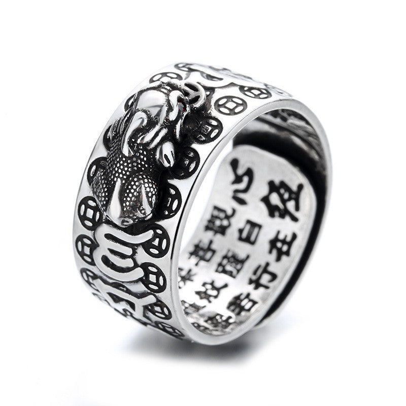 Close up view of a silver Pixiu ring with mantra engravings on the inside