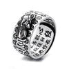 Close up view of a silver Pixiu ring with mantra engravings on the inside