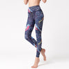 Woman wearing high-waisted yoga leggings with a blue floral and bird pattern
