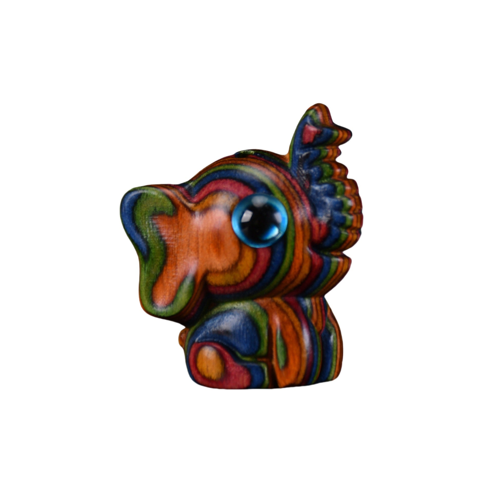 Small colorful rainbow wood elephant figurine sitting on a wooden surface