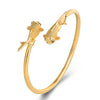 Open copper bangle with two gold-tone koi fish and red eyes
