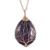 Close up of a purple amethyst teardrop pendant with copper tree of life wire wrapping
