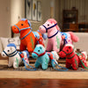 Group of colorful embroidered plush horse dolls sitting on a wooden table