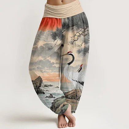Model wearing loose fitting cotton harem pants with a crane and landscape print