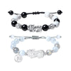 Close up of a wrist wearing a beaded bracelet with a silver Pixiu charm