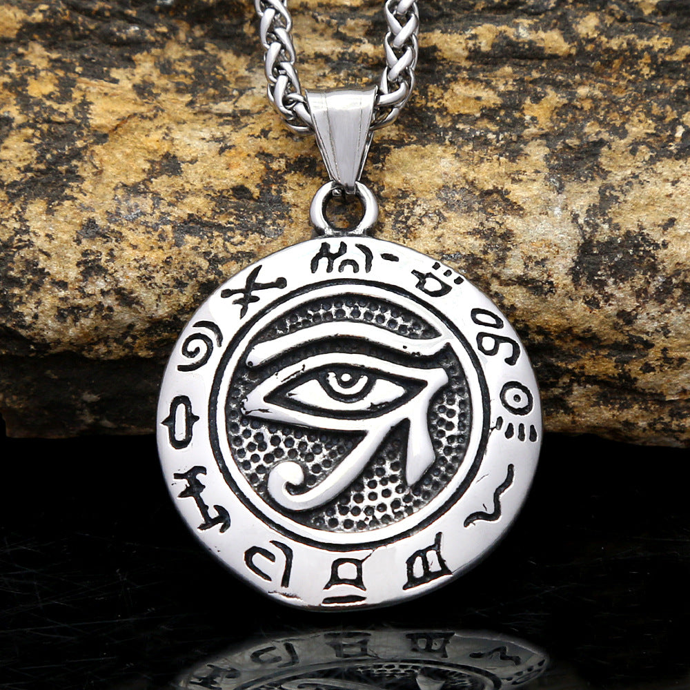Round titanium steel pendant with the Eye of Horus symbol and ancient script border