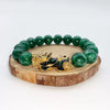Green jade beaded bracelet with gold tone Pixiu charm on wood slice