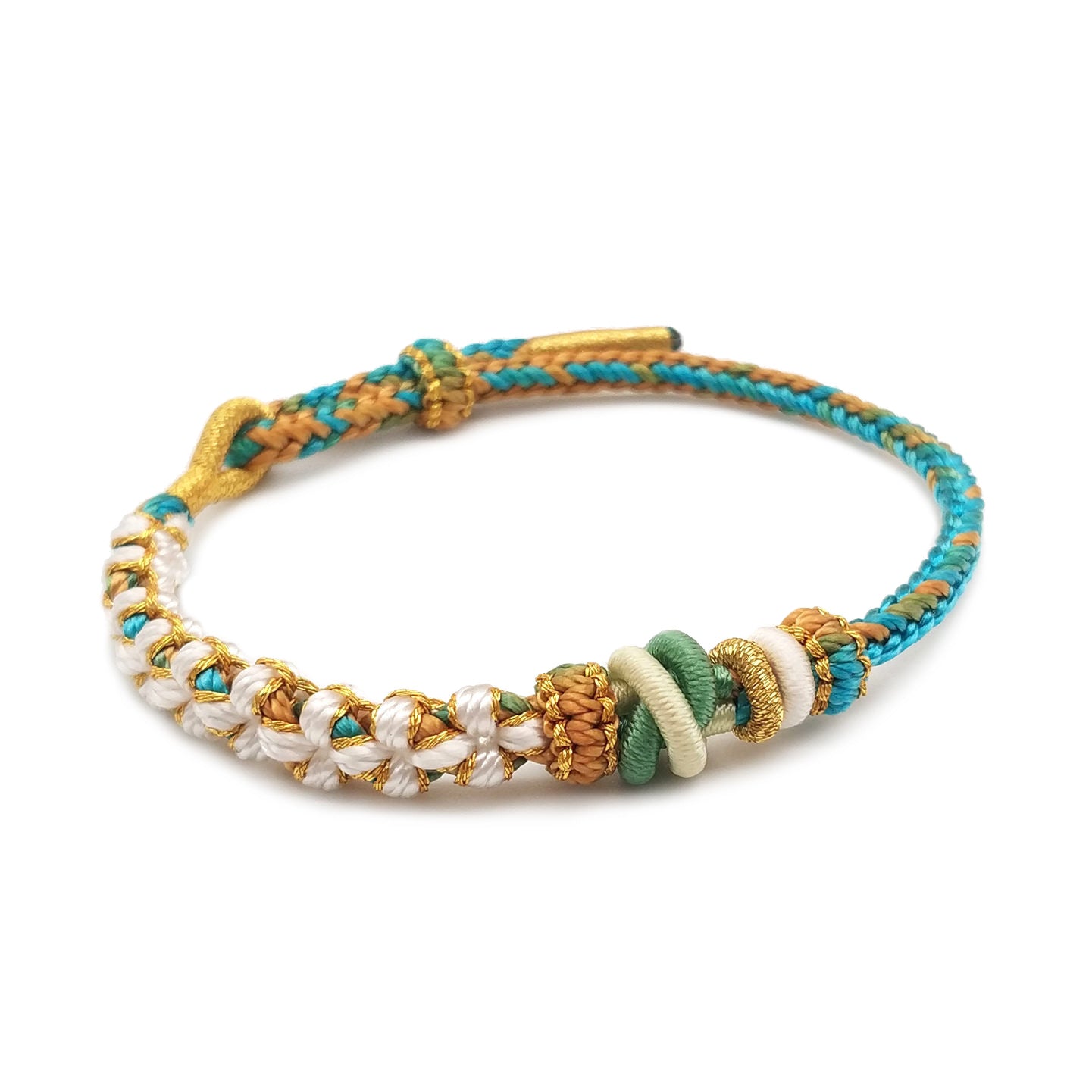 Close-up of a handwoven cord bracelet with green, white and gold beads against a white background