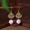 Gold-tone earrings with blue and purple enamel flower design and pink crystal beads