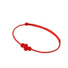 Close up of a thin red string bracelet with a Ruyi knot on a wrist