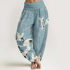 A pair of light blue loose-fitting cotton harem pants featuring a white crane print