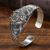 Close-up of a silver-plated cuff bracelet with a Garuda bird head design worn on a wrist