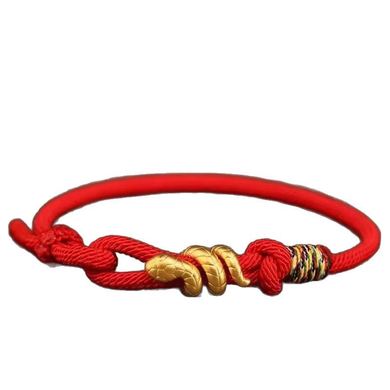 Close up of a red woven cord bracelet with a gold snake charm