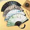 A collection of four open folding fans with black and white frames showing nature art.