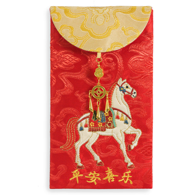 Red fabric envelope with white embroidered horse and gold-tone hanging ornament