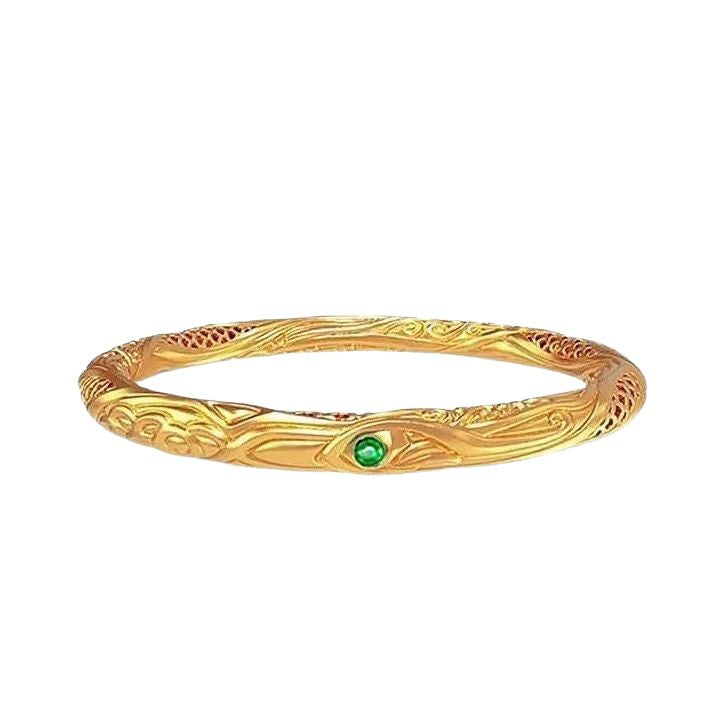 Gold tone copper bangle with geometric engraving and green stone
