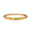Gold tone copper bangle with geometric engraving and green stone