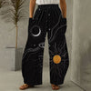 Woman wearing black wide-leg harem pants with white line art of sun, moon, and stars