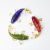Three colorful koi fish ornaments made of crystal chips and resin on a white background