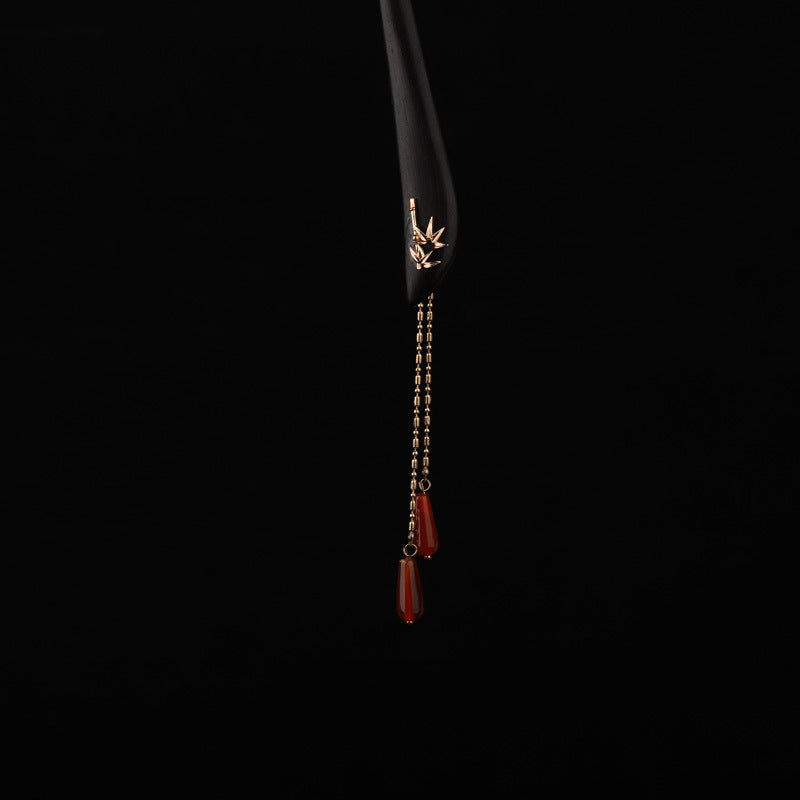 Black wooden hairpin with gold bamboo detail and hanging red agate beads