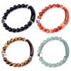 Four natural stone bracelets with heart charms on a white background