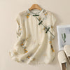 Back view of a cream sleeveless top with yellow floral print on a hanger