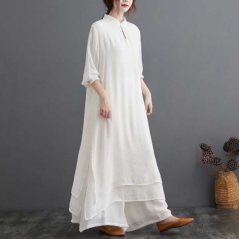 Woman wearing a white cotton meditation outfit with a layered tunic and wide pants