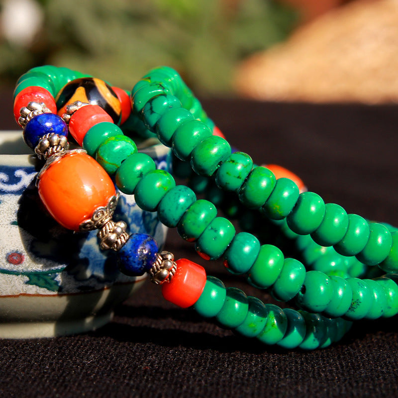 Green turquoise 108 bead mala bracelet with Dzi charm wrapped on wrist
