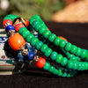 Green turquoise 108 bead mala bracelet with Dzi charm wrapped on wrist