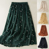 Dark green pleated midi skirt with white polka dots and an elastic waistband