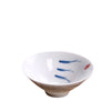 White porcelain teacup with blue hand painted koi fish design on a bamboo mat