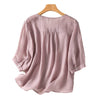 Back view of a pink cotton linen women's t-shirt on a hanger