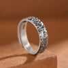 Silver-tone copper ring with engraved cloud patterns on a brown background