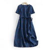 Blue polka dot midi dress with short sleeves and a tie waist hanging on a hanger