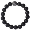 Close up of a black lava rock beaded bracelet with a silver dragon scale charm
